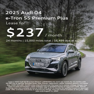 2025 Audi Q4 55 e-tron driving at an angle view